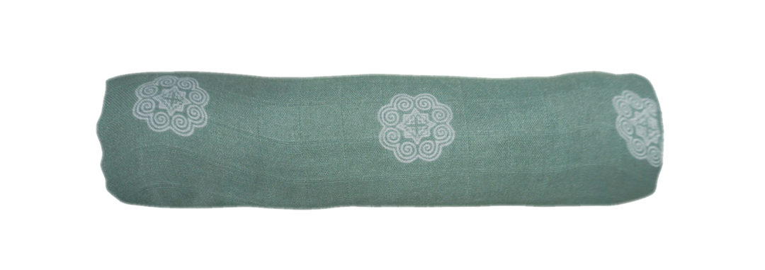 The sage green elephant print muslin swaddle can be rolled up to be used as head rest or easy storage.